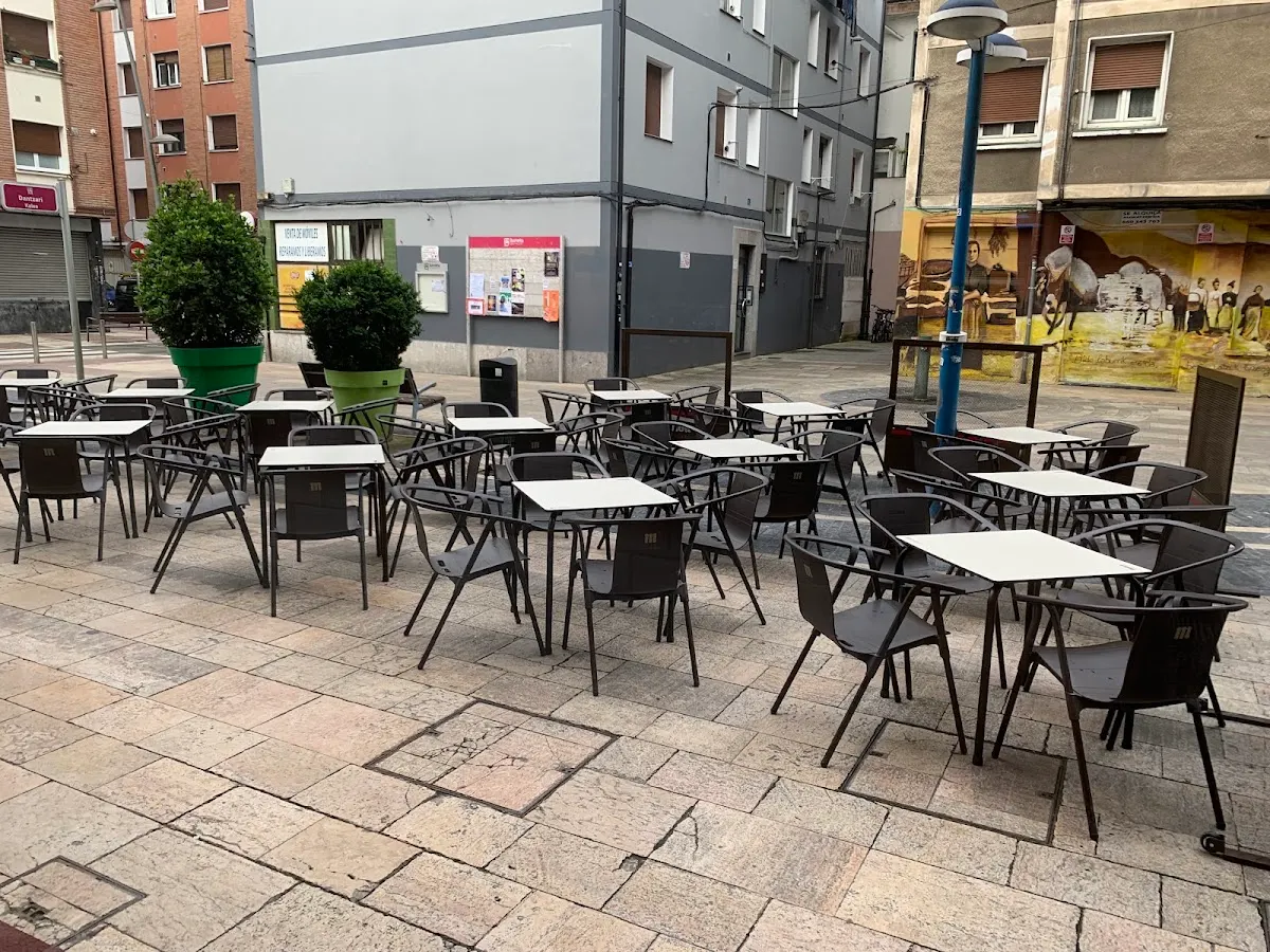 Terraza exterior de Bodeguilla Iurreta con mesas y sillas.