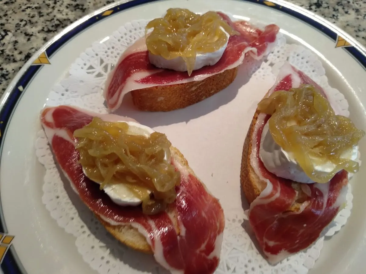 Pintxos de pan con jamón, queso y cebolla caramelizada en Cafetería Lupetza