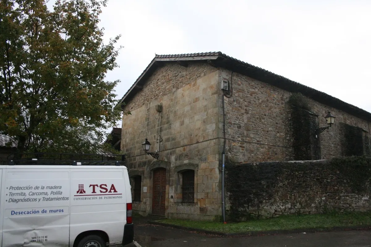 Vehículo de Técnica Sanitaria junto a un edificio de piedra.