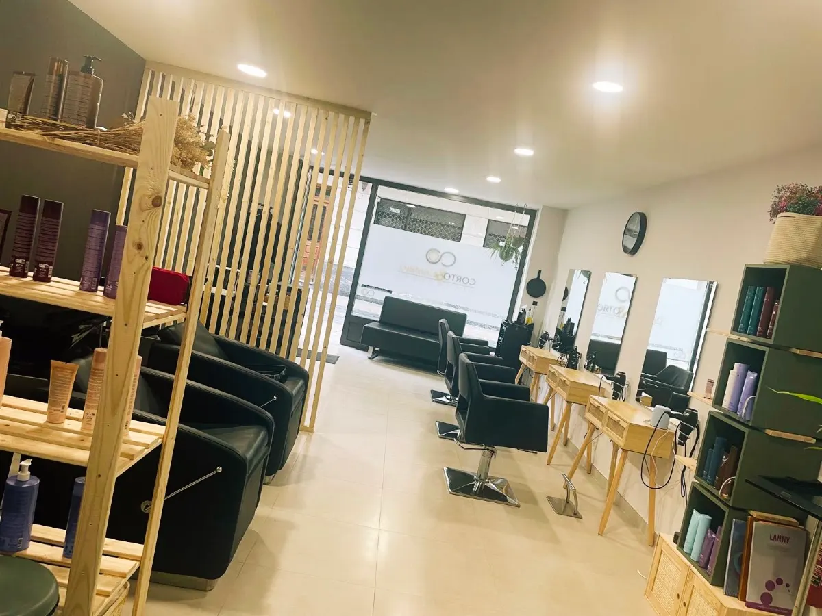 Interior de Corto & Cambio con sillones y puestos de peluquería