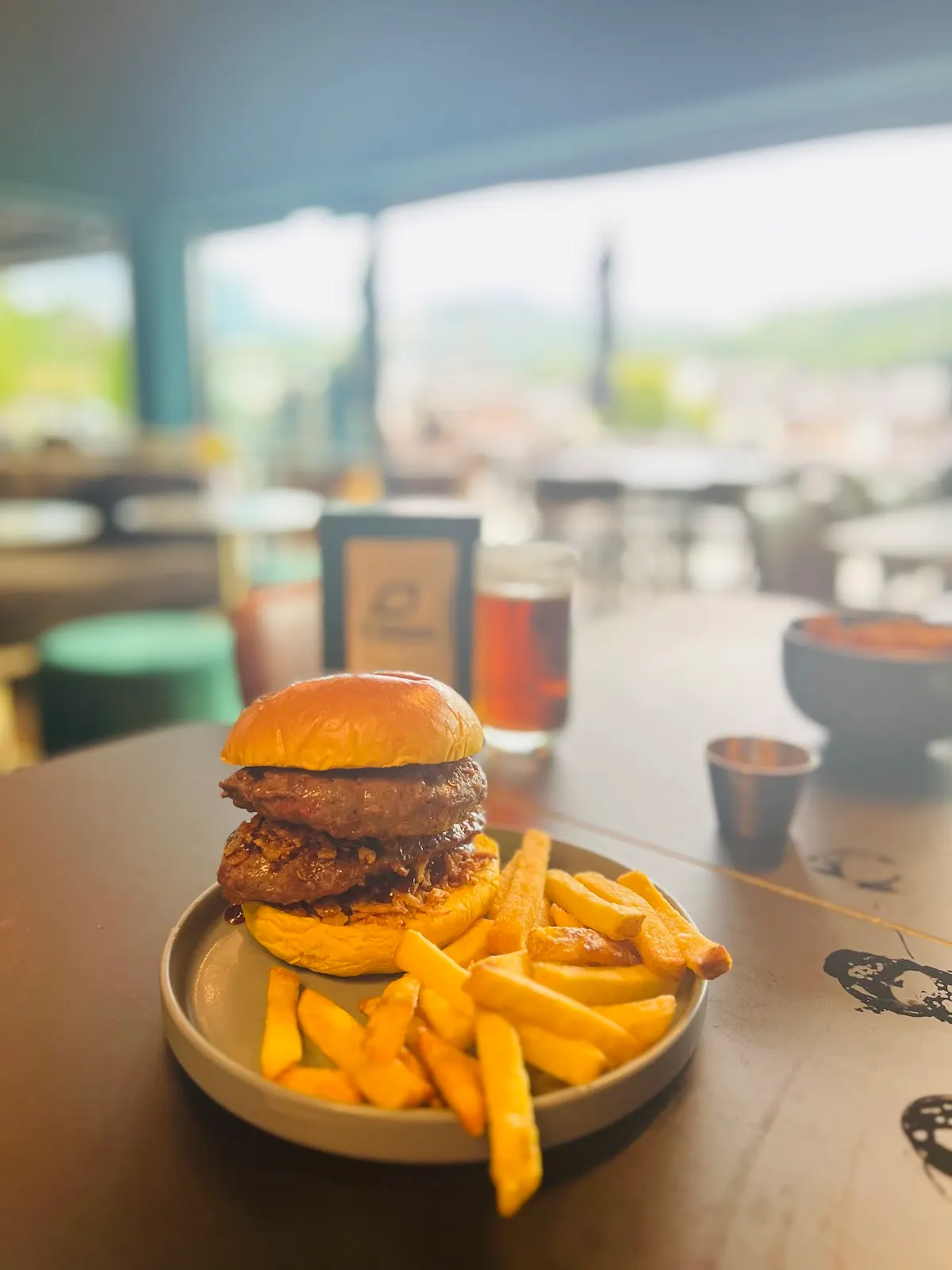 Hamburguesa con patatas fritas servida en una mesa de El Korner de Durango.