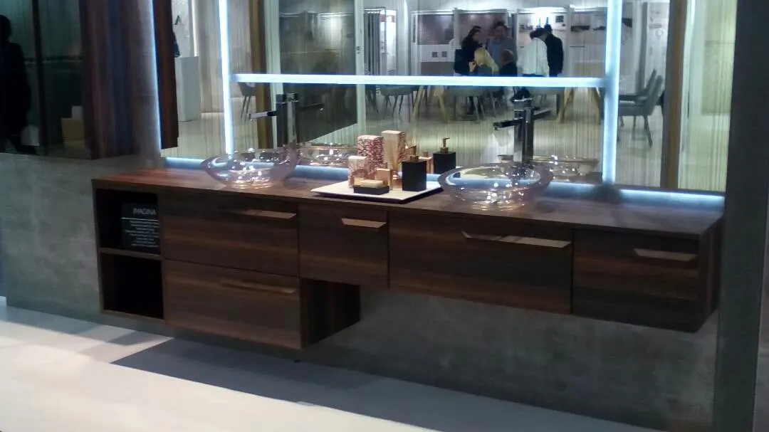 Mueble de lavabo de madera con dos lavamanos en una estancia interior.
