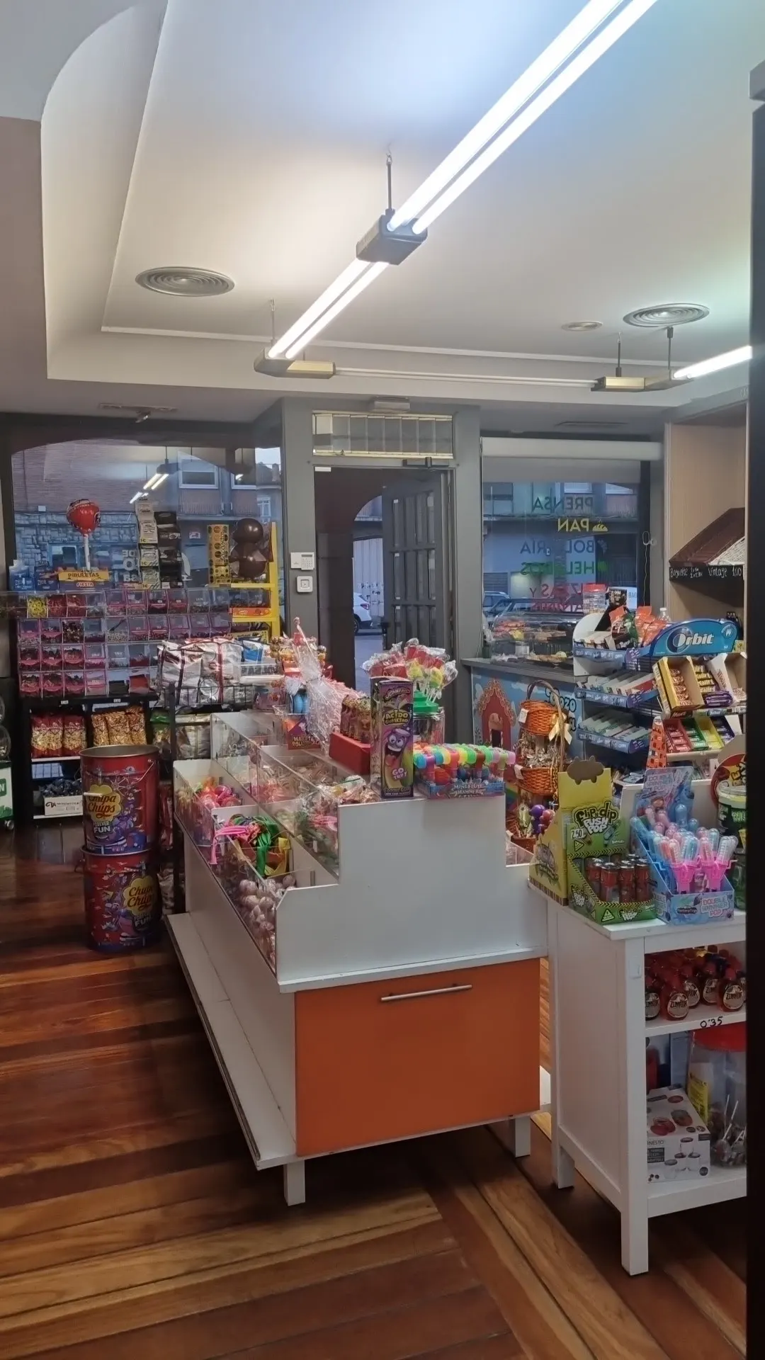 Interior de Gozo Berria con estanterías de golosinas, bebidas y otros productos.
