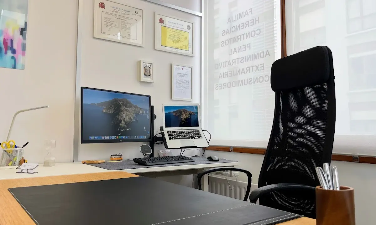 Puesto de trabajo en el despacho de Jon Rivas Montero, con ordenador y documentación enmarcada