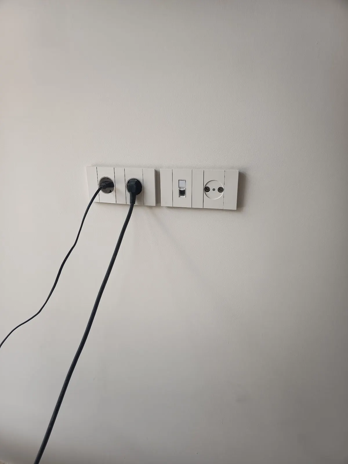 Tomas de corriente y conexiones eléctricas en una pared.