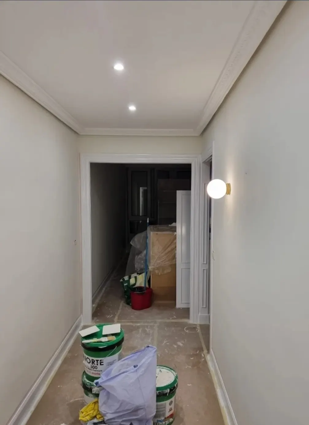 Pasillo en proceso de reforma con cubos y materiales, asociado a P.Duarte pintura y decoraciones