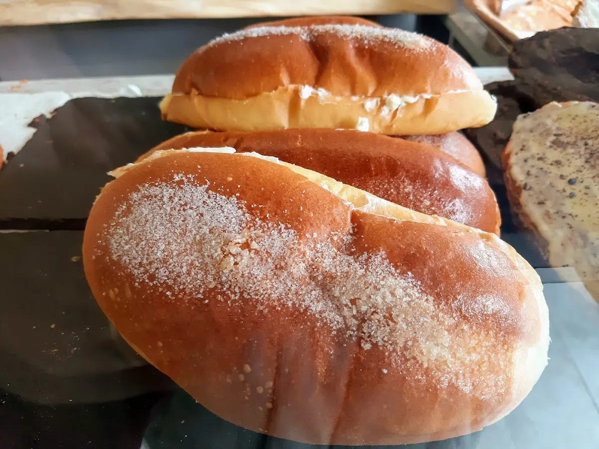 Panes dulces recién horneados expuestos en una bandeja.