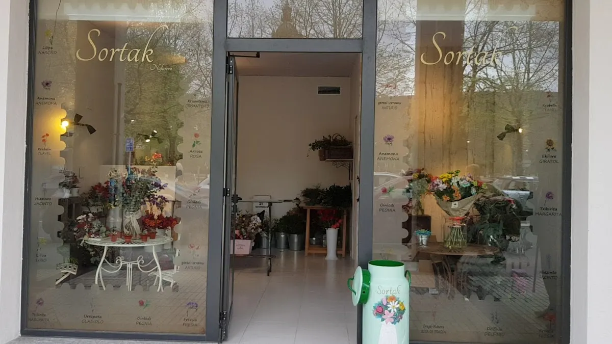 Fachada de la floristería Sortak Nafarroa en Amorebieta-Etxano, con plantas y arreglos en el escaparate.