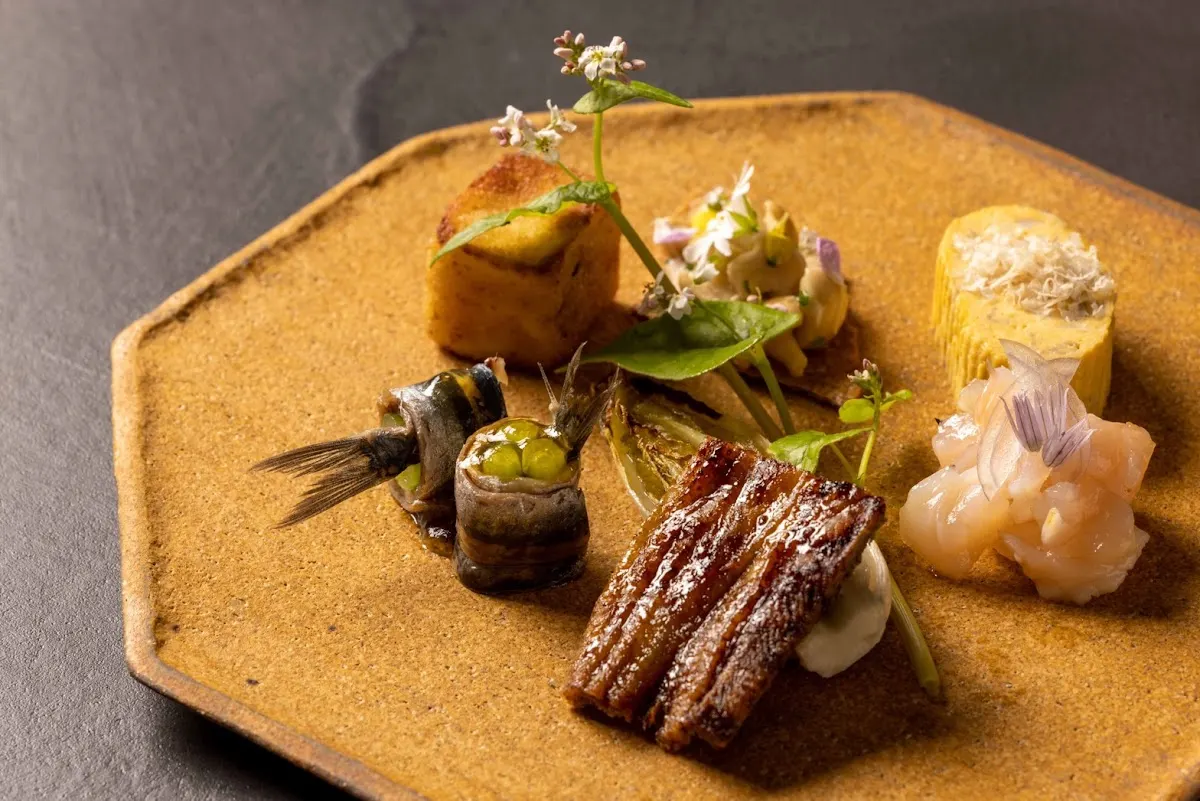 Plato de Txispa con varios bocados, verduras y marisco